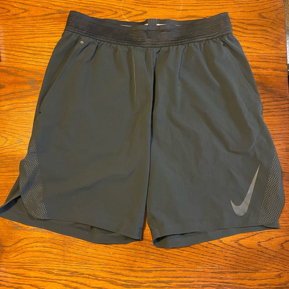 NIKE- men’s Dri Fit running shorts with elastic waist and pockets.